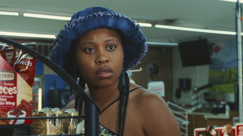 Dominique Fishback as Dre standing in grocery store in Swarm