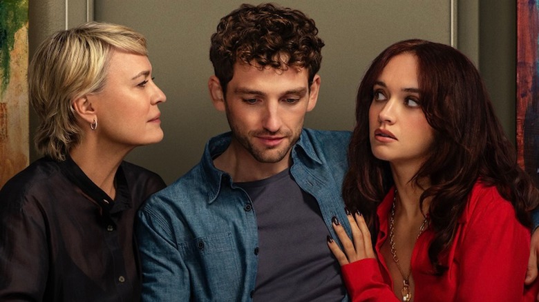Robin Wright as Laura Sanderson looking at Laurie Davidson as Daniel Sanderson while Olivia Cooke as Cherry Laine touches his chest in The Girlfriend