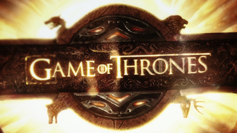 Game of Thrones into with four animal emblems in front of a glowing gold background