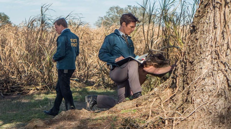 Marty Hart (Woody Harrelson) and Rust Cohle (Matthew McConaughey) investigate a crime scene in True Detective
