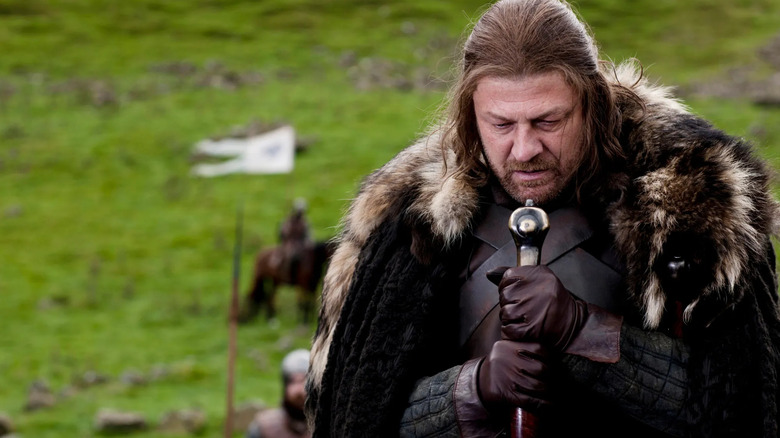 Ned Stark (Sean Bean) solemnly holds his sword in Game of Thrones