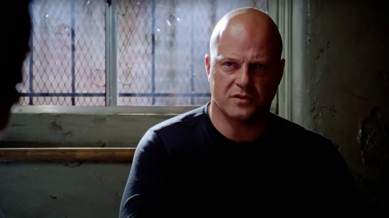 Vic Mackey (Michael Chiklis) speaks tersely in a dark room in The Shield