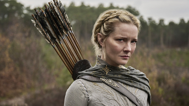 Morfydd Clark as Galadriel with bows affixed to her back in Lord Of The Rings: The Rings Of Power