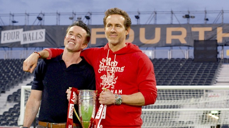 Rob Mac and Ryan Reynolds holding a trophy in Welcome to Wrexham Season 4