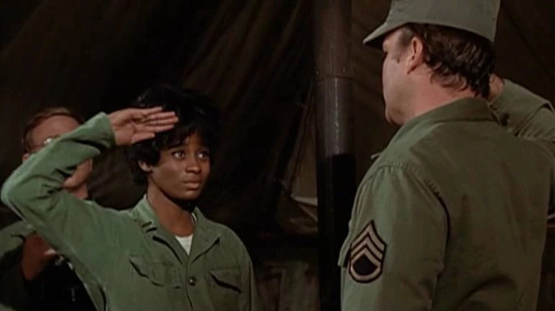 Ginger Bayliss (Odessa Cleveland) salutes a soldier in M*A*S*H