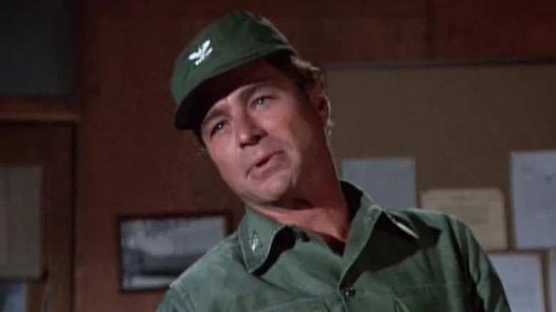 Colonel Sam Flagg (Edward Winter) speaks in an office in M*A*S*H