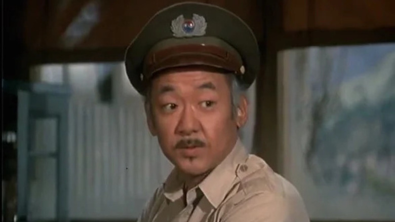Sam Pak (Pat Morita) stands in a South Korean officer's uniform in M*A*S*H