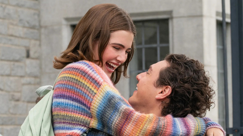 Ella Bright as Hannah smiling and being lifted up by Belmont Campbell as Garrett in Off Campus
