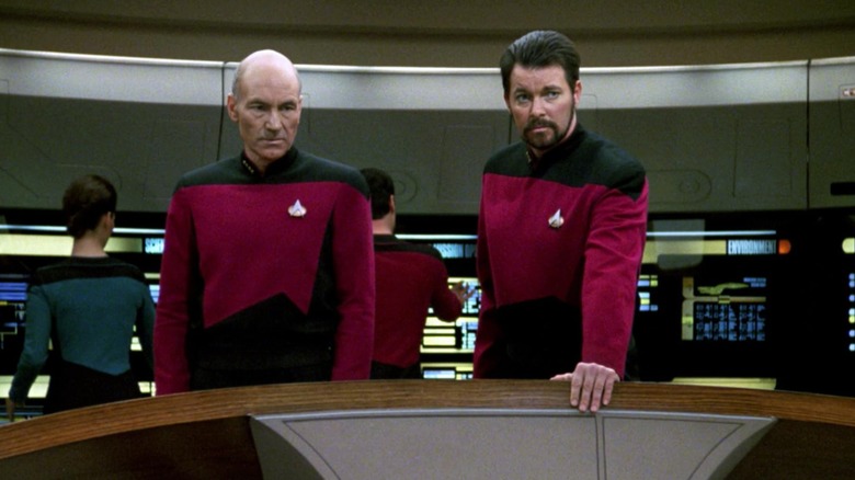 Jean-Luc Picard and William T. Riker look ahead, concerned, in "Star Trek: The Next Generation."