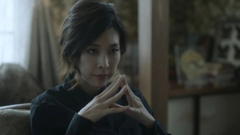 Sara "Sherlock" Shelly Futaba (Yūko Takeuchi) touches fingertips thoughtfully in Miss Sherlock