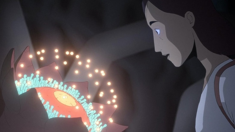 Ursula looking at glowing flower