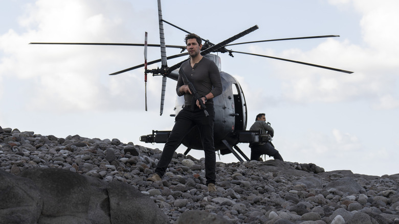 John Krasinski as Jack Ryan stood in front of a helicopter on Jack Ryan