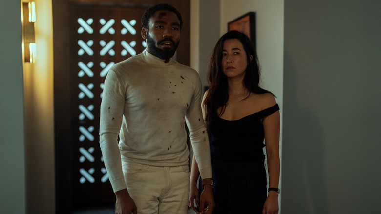 Donald Glover and Maya Erskine as Mr. and Mrs. Smith standing in front of a door on Mr & Mrs Smith
