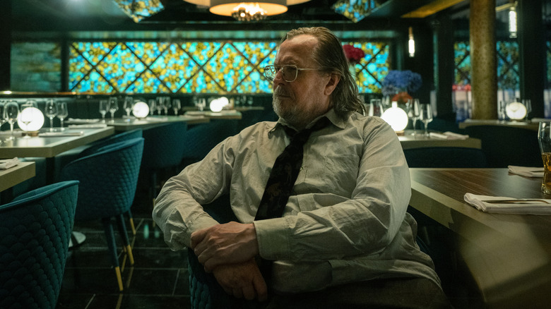 Gary Oldman as Jackson Lamb sat in a restaurant on Slow Horses