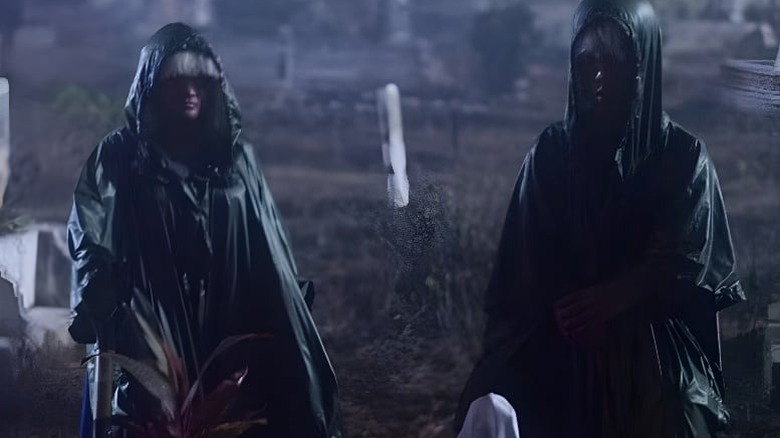 Two hooded figures standing next to each other on "Folklore."