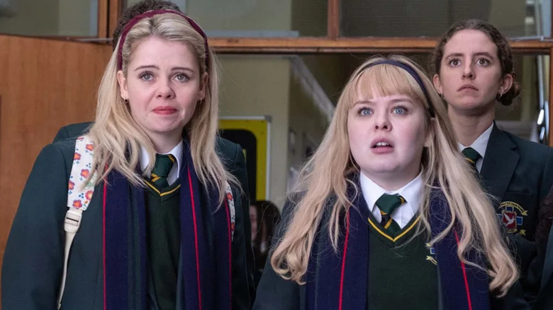Saoirse-Monica Jackson as Erin, in Catholic school outfit next to Nicola Coughlan and Louisa Harland as Orla in Derry Girls