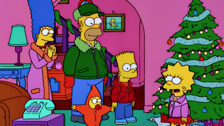 The Simpsons gather around a Christmas tree in "The Simpsons."