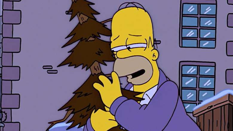 Homer hugs a Christmas tree in "The Simpsons."