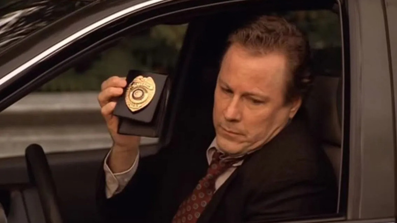 John Heard as Vin Makazian, flashing his detective badge in The Sopranos.