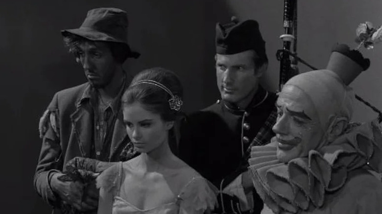 The hobo, ballet dancer, bagpiper, and clown looking serious together
