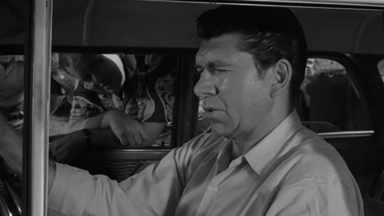 Steve Brand sits in his car in The Twilight Zone