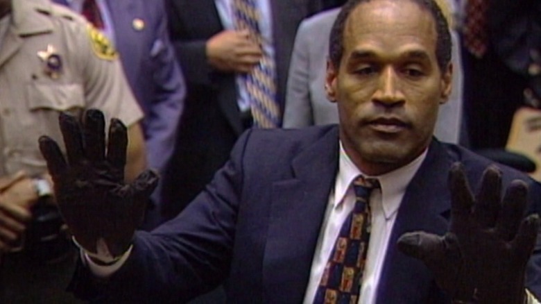 OJ Simpson holding up both half-gloved hands, from OJ: Made in America