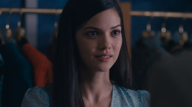 Füsun smiling as she looks on