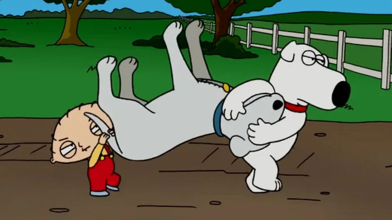 Stewie and Brian carrying a dog upside down in Family Guy