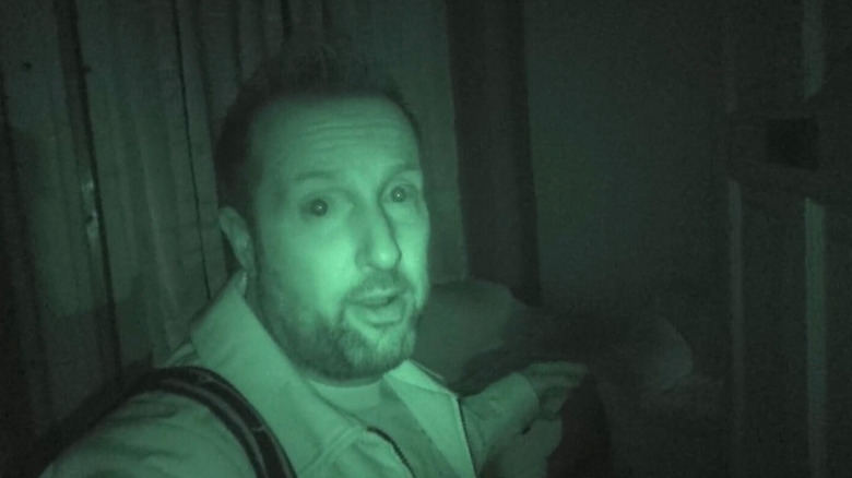 Billy Tolley looks at a night vision camera in Ghost Adventures