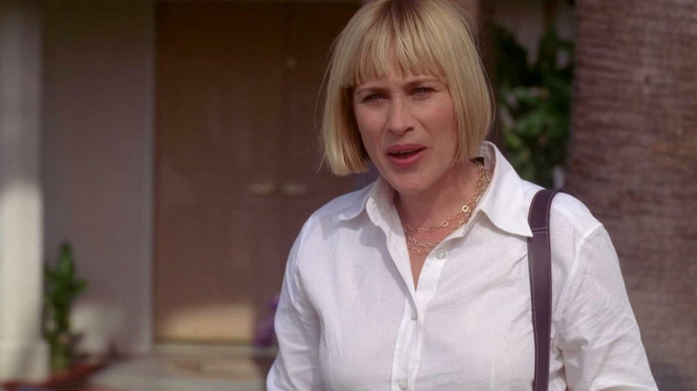 Allison Dubois stands in front of a house in Medium