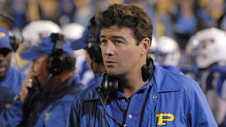 Kyle Chandler as Coach Taylor coaches on the sideline in Friday Night Lights