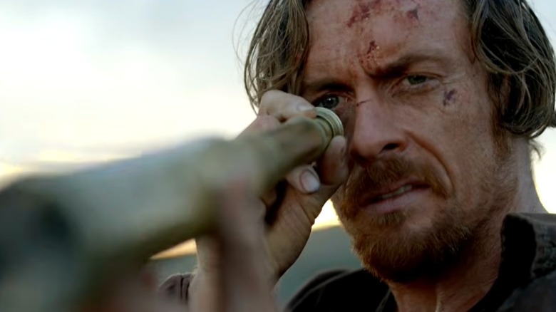 James Flint looking through a spyglass