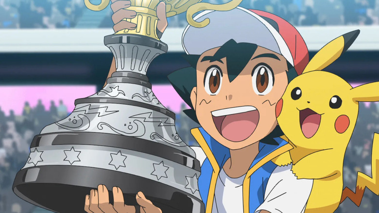 Ash Ketchum holding a trophy with Pikachu in Pokemon the anime