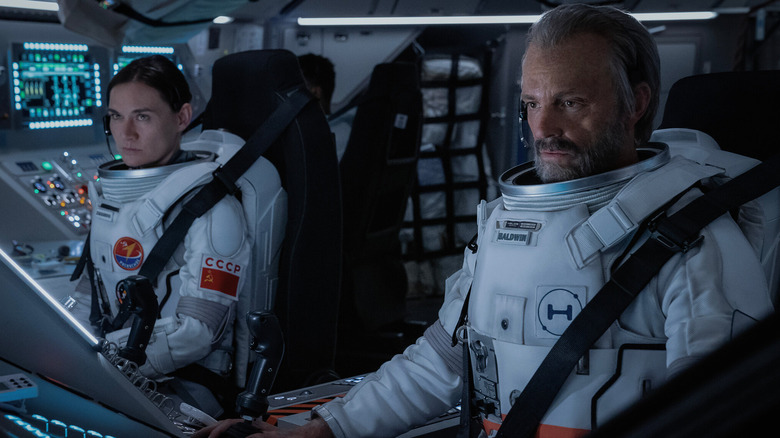 Masha Mashkova as Svetlana Zakharova and Joel Kinnaman as Edward "Ed" Baldwin, piloting a space craft together in For All Mankind.