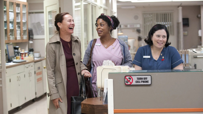 Jenna James (Laurie Metcalf) laughs while speaking to Didi Ortley (Niecy Nash) and Dawn Forchette (Alex Borstein) at a nurses' station in Getting On (2013)