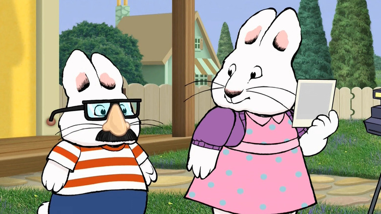 Max wearing funny glasses next to Ruby looking at him holding a Polaroid in Max & Ruby