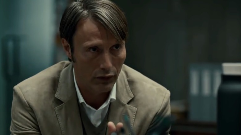 Hannibal Lecter leaning forward and speaking