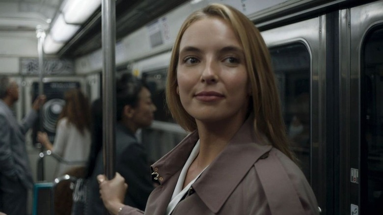 Villanelle smiling on a subway train