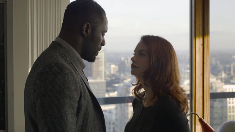 Luther and Alice standing by a window and speaking