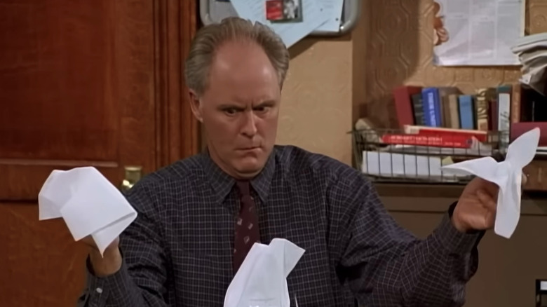 John Lithgow as Dick Solomon stares at napkins in 3rd Rock from the Sun