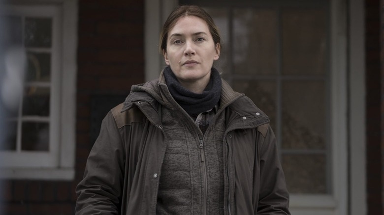 Kate Winslet as Mare Sheehan standing outside a house