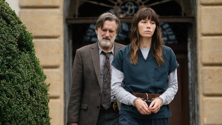 Bill Pullman as Detective Harry Ambrose walking out Jessica Biel as Cora handcuffed in The Sinner