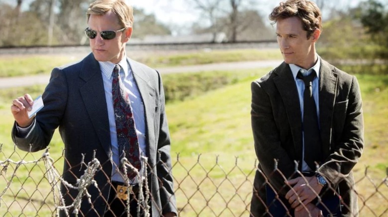 Woody Harrelson and Matthew McConaughey in True Detective next to a fence
