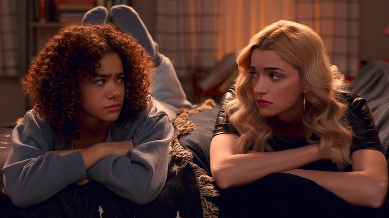 Ginny Miller (Antonia Gentry) and Georgia Miller (Brianne Howey) lay down next to each other suspiciously in Ginny & Georgia