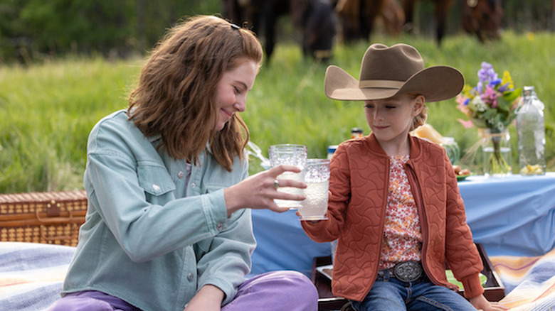 Amy Fleming (Amber Marshall) toasts Lyndy Borden (Emmanuella Spencer) at a picnic in Heartland