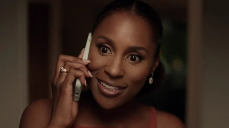 Issa Dee (Issa Rae) speaks excitedly on her cellphone in Insecure