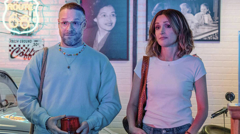 Will (Seth Rogen) and Sylvia (Rose Byrne) stand next to each other in a '50s themed room in Platonic
