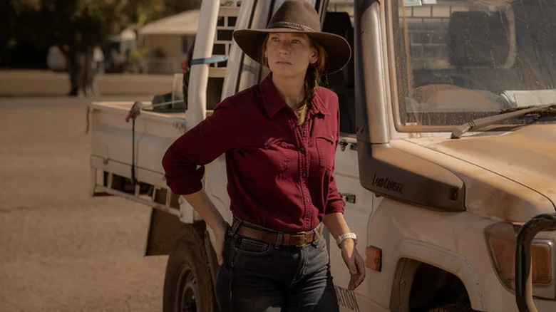 Anna Torv's Emily Lawson standing beside a truck on Territory