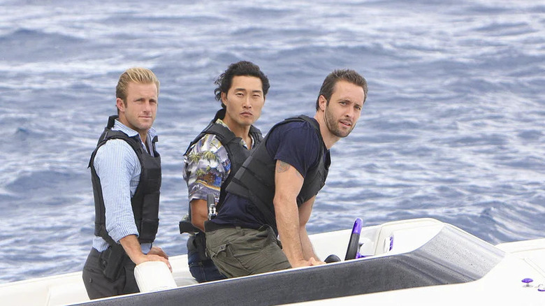 Danny Williams, Chin Ho Kelly, and Steve McGarrett piloting a boat in the ocean