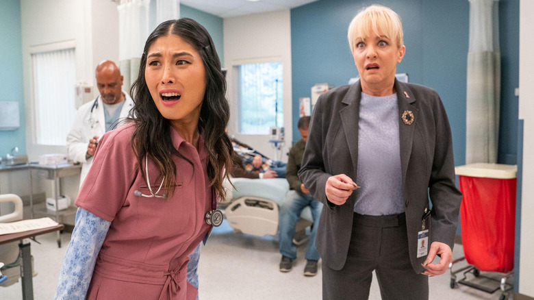 Kahyun Kim as Serena and Wendi McLendon-Covey as Joyce looking horrified in St. Denis Medical